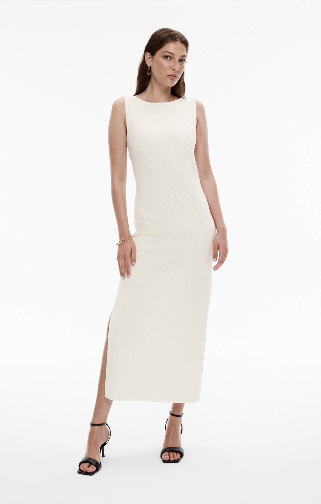 Woman in ivory sleeveless knit dress